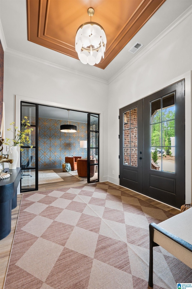 1761 Gable Way, Hoover, AL 35244 - entrance foyer with french doors, a tray ceiling, a chandelier, ornamental molding, and baseboards