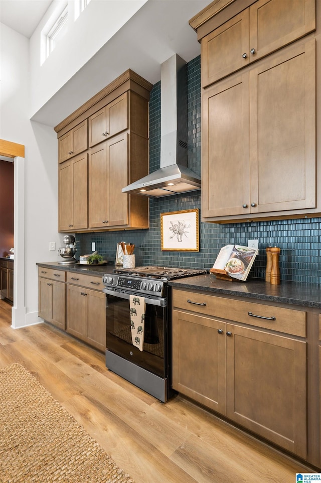 1761 Gable Way, Hoover, AL 35244 - kitchen with wall chimney range hood, stainless steel range with gas stovetop, dark countertops, backsplash, and a towering ceiling