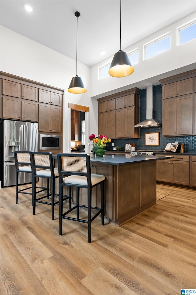 1761 Gable Way, Hoover, AL 35244 - kitchen featuring appliances with stainless steel finishes, wall chimney range hood, dark countertops, backsplash, and hanging light fixtures