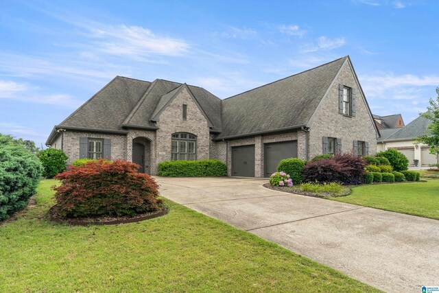 1343 Chapel St, Hoover, AL 35226 - french country inspired facade with brick siding, concrete driveway, and roof with shingles