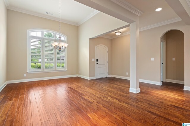 1343 Chapel St, Hoover, AL 35226 - entrance foyer featuring arched walkways, dark wood-type flooring, ornamental molding, a chandelier, and baseboards