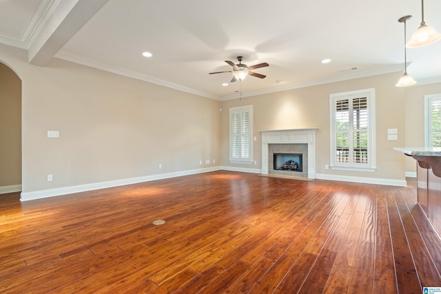 1343 Chapel St, Hoover, AL 35226 - unfurnished living room featuring dark wood finished floors, a ceiling fan, arched walkways, ornamental molding, and a premium fireplace