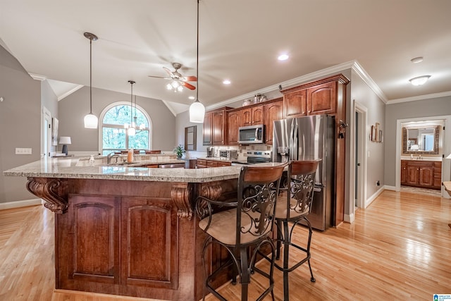 121 Middle Ridge Trl, Springville, AL 35146 - kitchen featuring stainless steel appliances, a breakfast bar area, a ceiling fan, light wood finished floors, and crown molding