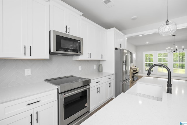 350 Shiloh Creek Dr, Calera, AL 35040 - kitchen featuring appliances with stainless steel finishes, a sink, tasteful backsplash, and white cabinets