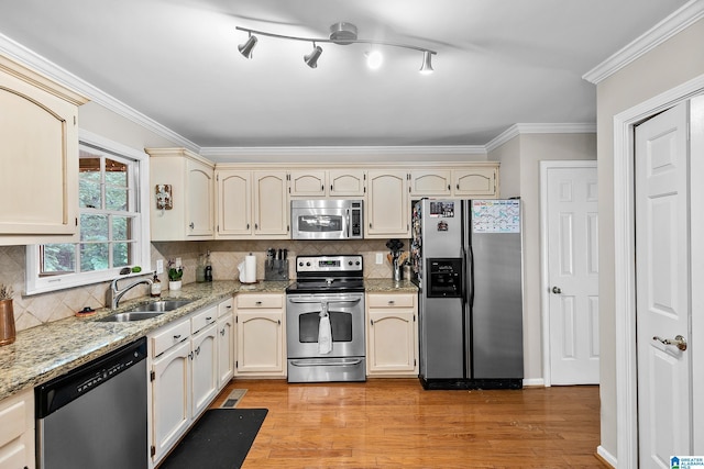 545 Russet Bend Dr, Hoover, AL 35244 - kitchen with stainless steel appliances, cream cabinets, a sink, ornamental molding, and light wood-style floors