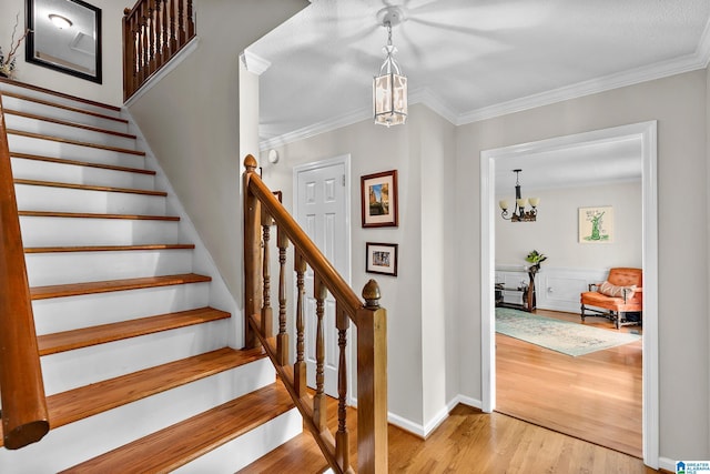 545 Russet Bend Dr, Hoover, AL 35244 - staircase with a chandelier, wood finished floors, ornamental molding, and baseboards