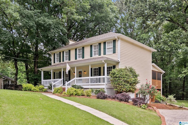 545 Russet Bend Dr, Hoover, AL 35244 - colonial-style house with covered porch, a front yard, a chimney, and view of scattered trees