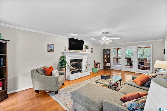 545 Russet Bend Dr, Hoover, AL 35244 - living room with wood finished floors, ornamental molding, a brick fireplace, a ceiling fan, and baseboards
