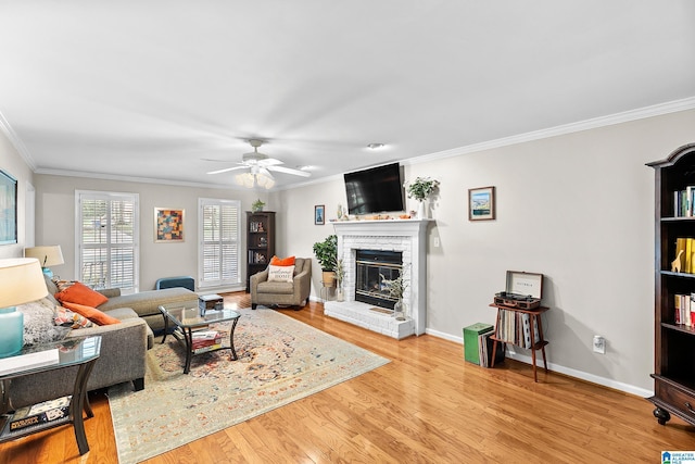 545 Russet Bend Dr, Hoover, AL 35244 - living room with crown molding, a fireplace, wood finished floors, a ceiling fan, and baseboards