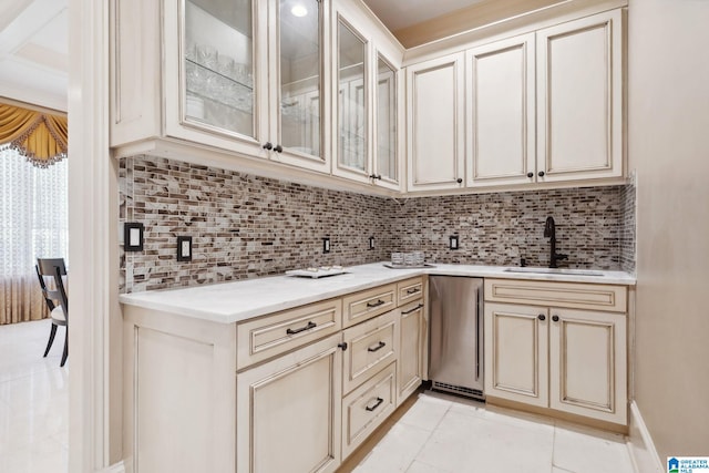 2821 Shook Hill Cir, Mountain Brook, AL 35223 - kitchen with a sink, cream cabinets, fridge, light tile patterned floors, and tasteful backsplash
