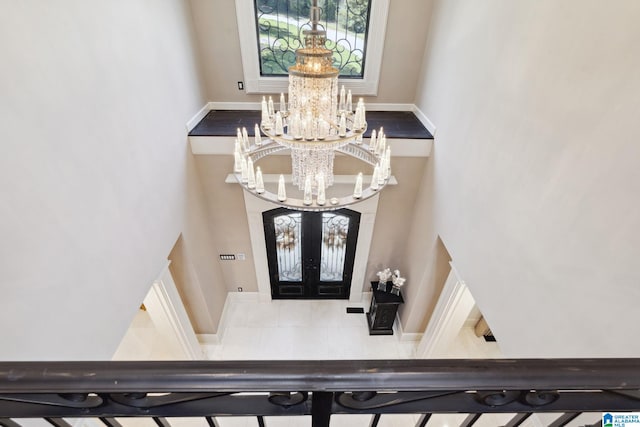 2821 Shook Hill Cir, Mountain Brook, AL 35223 - entryway featuring a chandelier, french doors, a towering ceiling, and baseboards
