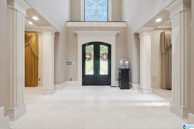 2821 Shook Hill Cir, Mountain Brook, AL 35223 - tiled foyer featuring ornate columns, a high ceiling, baseboards, and french doors