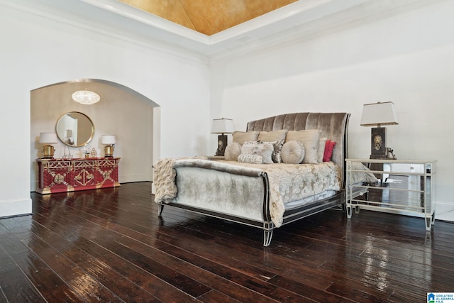 2821 Shook Hill Cir, Mountain Brook, AL 35223 - bedroom with wood-type flooring, arched walkways, crown molding, and a high ceiling