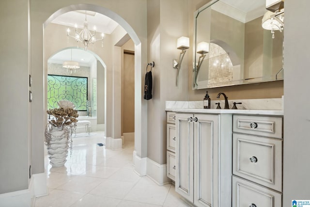 2821 Shook Hill Cir, Mountain Brook, AL 35223 - full bathroom featuring a chandelier, ornamental molding, vanity, baseboards, and a tub