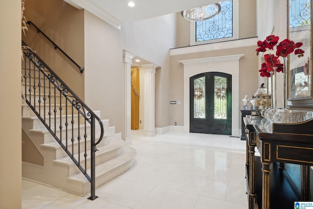 2821 Shook Hill Cir, Mountain Brook, AL 35223 - foyer featuring a high ceiling, stairway, french doors, a chandelier, and baseboards