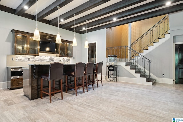 2821 Shook Hill Cir, Mountain Brook, AL 35223 - kitchen featuring tasteful backsplash, dark brown cabinets, beamed ceiling, baseboards, and light countertops