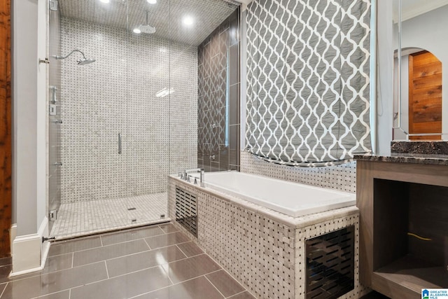 2821 Shook Hill Cir, Mountain Brook, AL 35223 - bathroom with a stall shower, tile patterned flooring, a garden tub, vanity, and crown molding