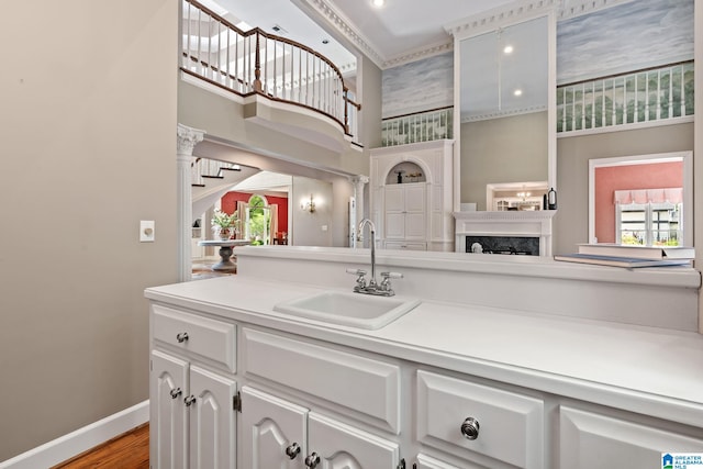 2100 Southwinds Cir, Hoover, AL 35244 - kitchen with a sink, a high ceiling, healthy amount of natural light, baseboards, and white cabinets