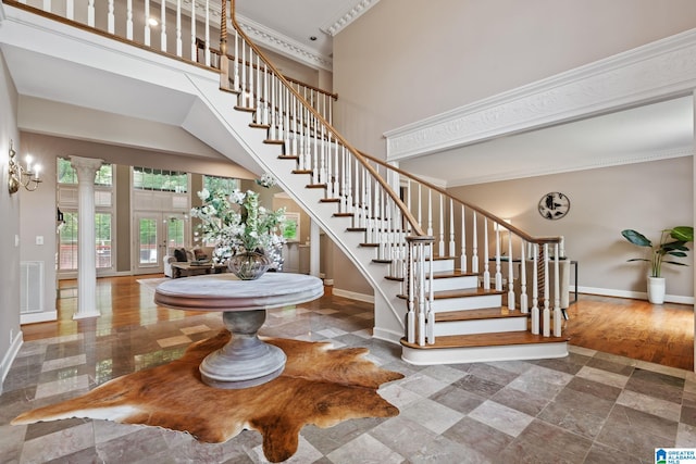 2100 Southwinds Cir, Hoover, AL 35244 - stairs featuring baseboards, a towering ceiling, decorative columns, french doors, and crown molding