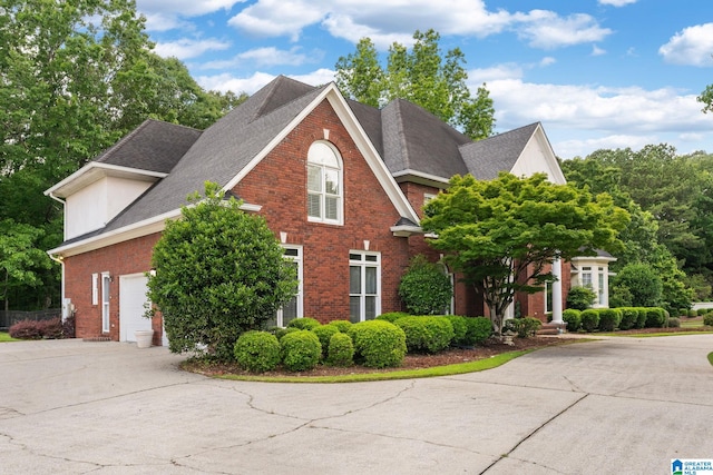 2100 Southwinds Cir, Hoover, AL 35244 - view of front of home featuring concrete driveway, brick siding, roof with shingles, and a garage