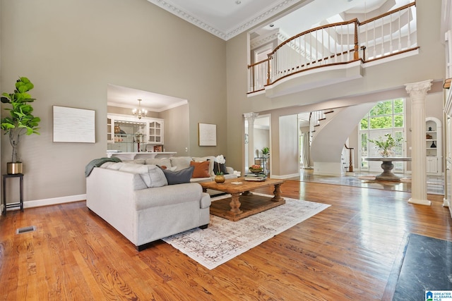 2100 Southwinds Cir, Hoover, AL 35244 - living area with a high ceiling, ornamental molding, ornate columns, baseboards, and wood finished floors