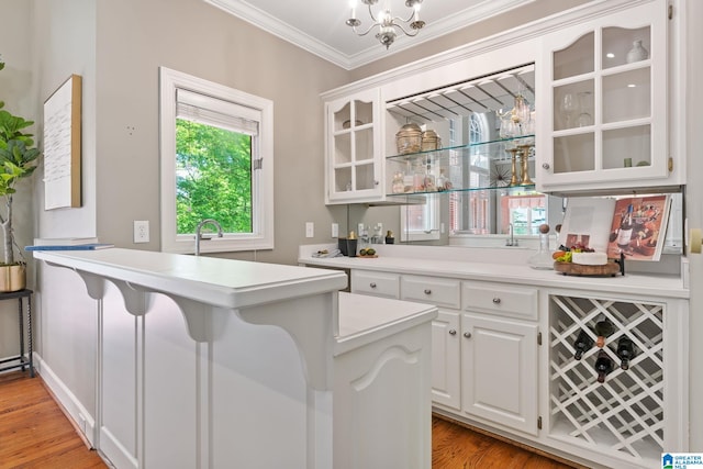 2100 Southwinds Cir, Hoover, AL 35244 - bar area featuring ornamental molding, light wood-style floors, and a chandelier