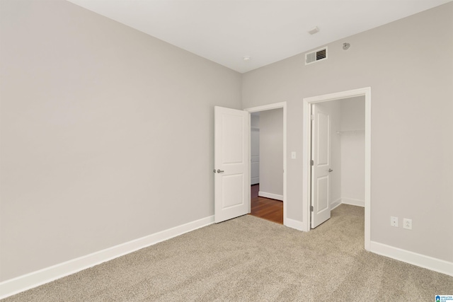 2024 2nd Ave N Unit 1703, Birmingham, AL 35203 - unfurnished bedroom with carpet floors, a spacious closet, baseboards, and a closet