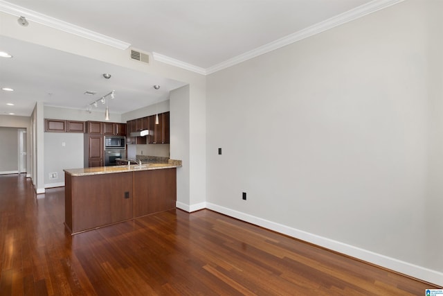 2024 2nd Ave N Unit 1703, Birmingham, AL 35203 - kitchen featuring built in microwave, stainless steel oven, a peninsula, baseboards, and dark wood finished floors
