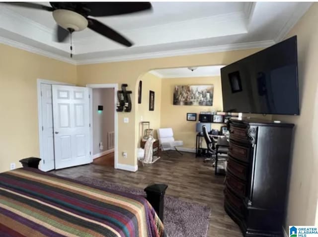 5616 Elliott Cir, Mccalla, AL 35111 - bedroom with arched walkways, a raised ceiling, dark wood-style floors, ornamental molding, and baseboards
