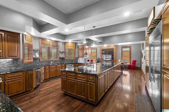 200 Asphodel Dr, Dothan, AL 36303 - kitchen featuring dark wood-type flooring, backsplash, an island with sink, and built in appliances