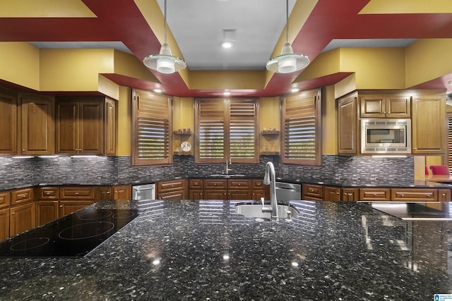 200 Asphodel Dr, Dothan, AL 36303 - kitchen featuring stainless steel microwave, black electric stovetop, brown cabinetry, and dark stone countertops