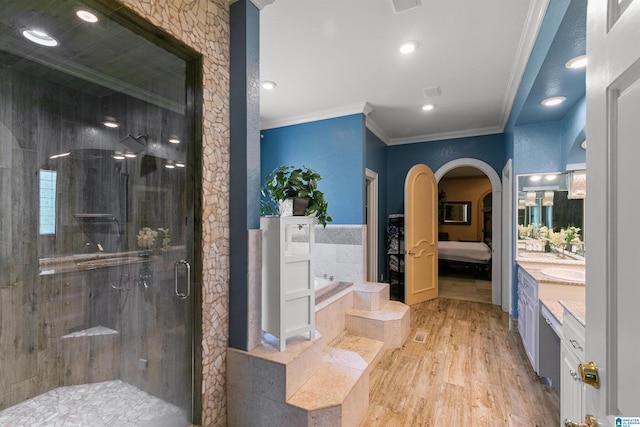 200 Asphodel Dr, Dothan, AL 36303 - ensuite bathroom with crown molding, a bath, vanity, wood finished floors, and a stall shower