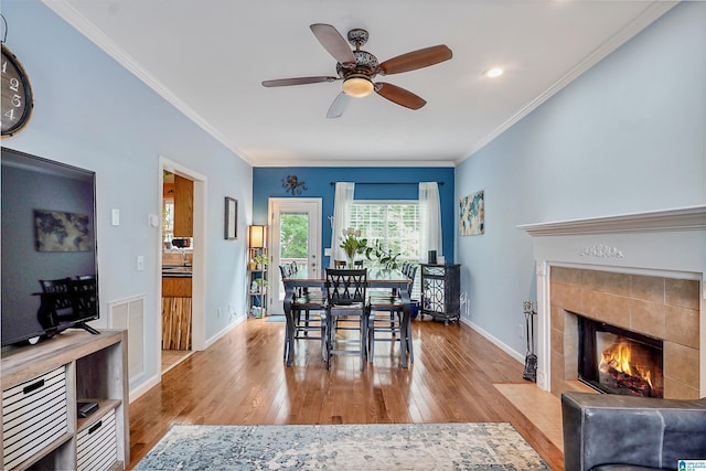 311 Hunter Hills Cir, Chelsea, AL 35043 - dining room featuring hardwood / wood-style floors, ceiling fan, a fireplace, ornamental molding, and baseboards