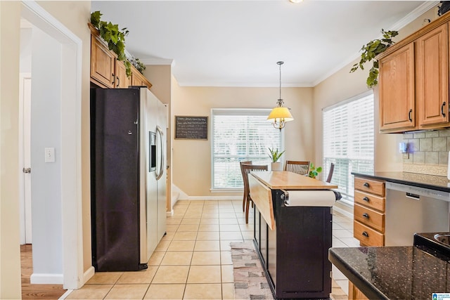 311 Hunter Hills Cir, Chelsea, AL 35043 - kitchen with stainless steel appliances, crown molding, baseboards, light tile patterned flooring, and decorative light fixtures