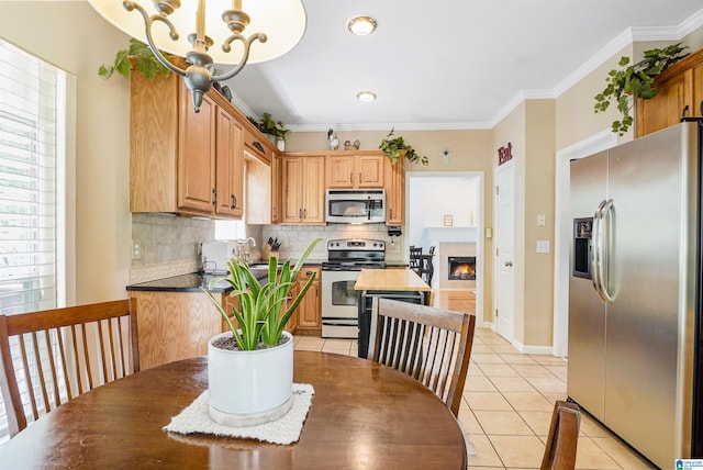 311 Hunter Hills Cir, Chelsea, AL 35043 - kitchen featuring stainless steel appliances, backsplash, light tile patterned flooring, a chandelier, and ornamental molding