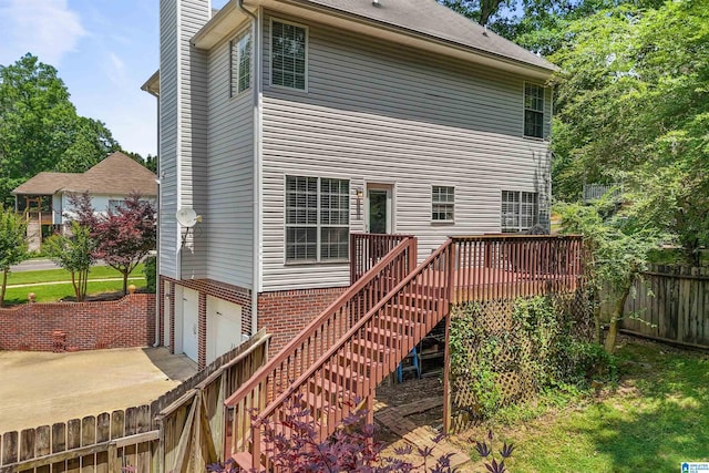 311 Hunter Hills Cir, Chelsea, AL 35043 - rear view of house featuring a garage, a wooden deck, stairs, a chimney, and concrete driveway