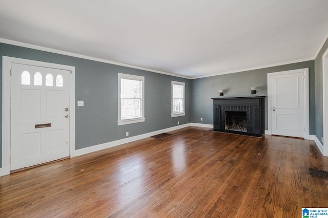 516 85th St, Birmingham, AL 35206 - unfurnished living room featuring ornamental molding, wood finished floors, a brick fireplace, and baseboards