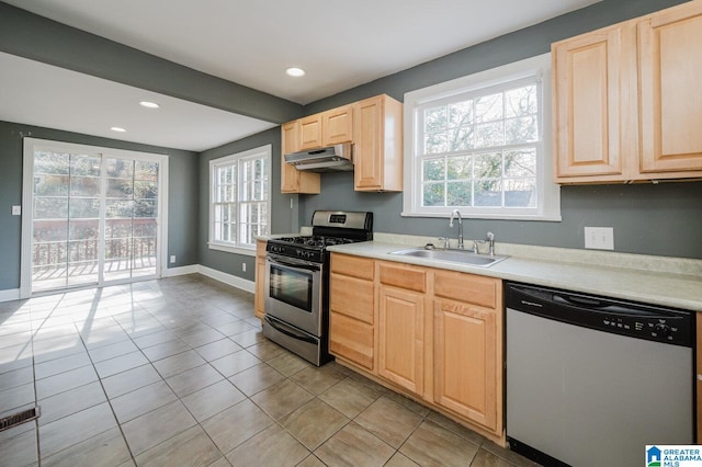 516 85th St, Birmingham, AL 35206 - kitchen with appliances with stainless steel finishes, a sink, under cabinet range hood, light brown cabinets, and plenty of natural light