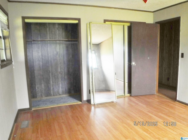 530 Sand Rock Ave, Leesburg, AL 35983 - unfurnished bedroom featuring wood finished floors, two closets, crown molding, and baseboards