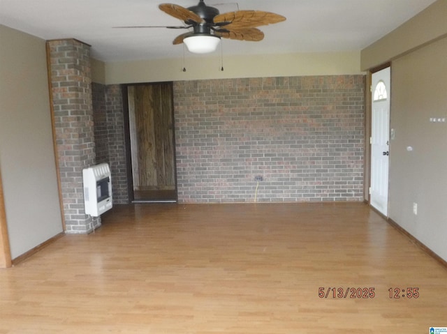 530 Sand Rock Ave, Leesburg, AL 35983 - unfurnished living room with heating unit, wood finished floors, a ceiling fan, brick wall, and baseboards
