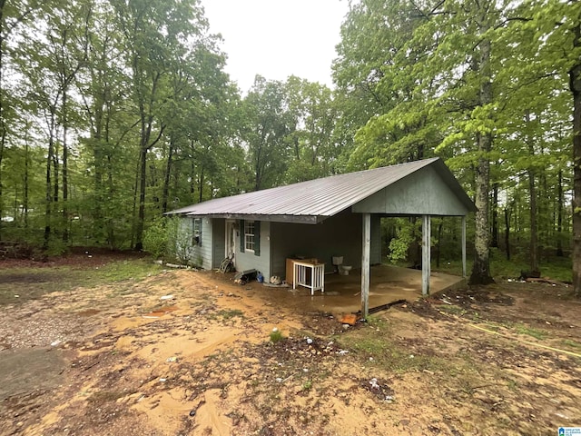 375 Little Dismal Rd, Arley, AL 35541 - view of side of property with metal roof, a carport, and a view of trees