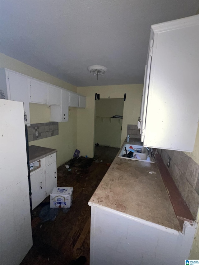 375 Little Dismal Rd, Arley, AL 35541 - kitchen with freestanding refrigerator, a sink, and white cabinetry