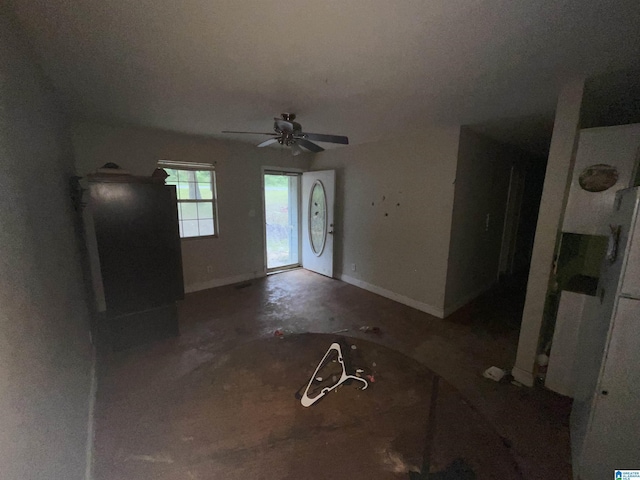 375 Little Dismal Rd, Arley, AL 35541 - unfurnished living room featuring concrete floors, baseboards, and a ceiling fan