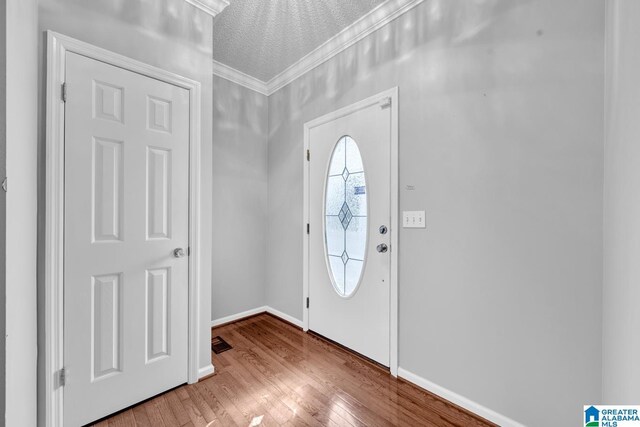 200 Shady Point Rd, Locust Fork, AL 35097 - foyer entrance featuring wood finished floors, crown molding, baseboards, and a textured ceiling