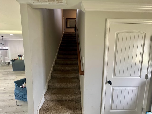 796 Michelle Mnr, Montevallo, AL 35115 - stairway featuring wood finished floors, a chandelier, and crown molding