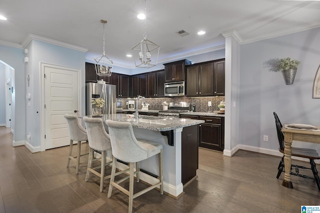 1037 Norman Way, Birmingham, AL 35242 - kitchen featuring stainless steel appliances, a sink, dark brown cabinetry, tasteful backsplash, and a kitchen bar
