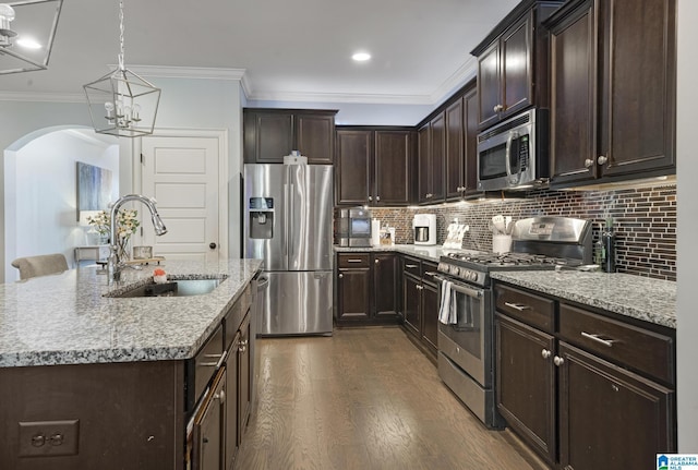 1037 Norman Way, Birmingham, AL 35242 - kitchen featuring appliances with stainless steel finishes, a sink, ornamental molding, light stone counters, and dark wood finished floors