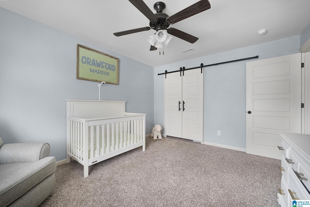 1037 Norman Way, Birmingham, AL 35242 - carpeted bedroom with a barn door, a crib, baseboards, and a ceiling fan