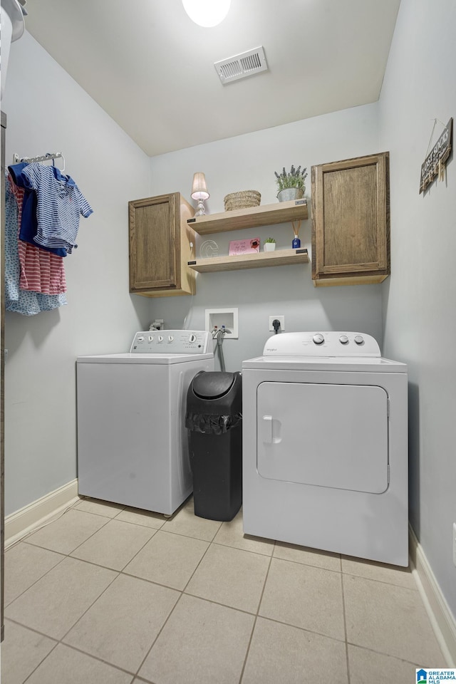 1037 Norman Way, Birmingham, AL 35242 - laundry area featuring cabinet space, separate washer and dryer, light tile patterned floors, and baseboards