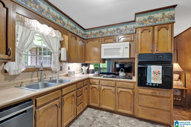5420 Pine St, Sylvan Springs, AL 35118 - kitchen with black appliances, a sink, light countertops, and brown cabinets